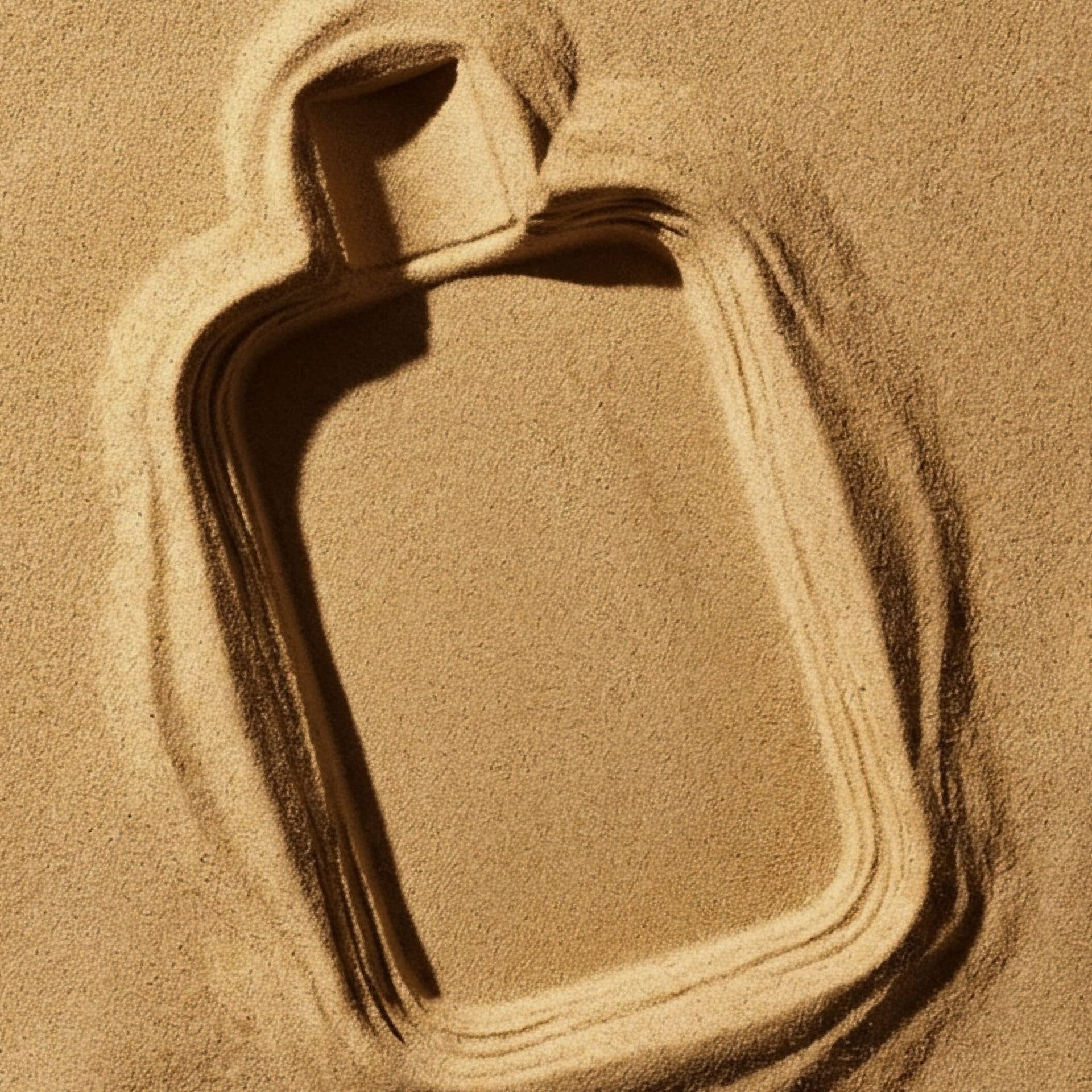 The shape of a bottle in sand